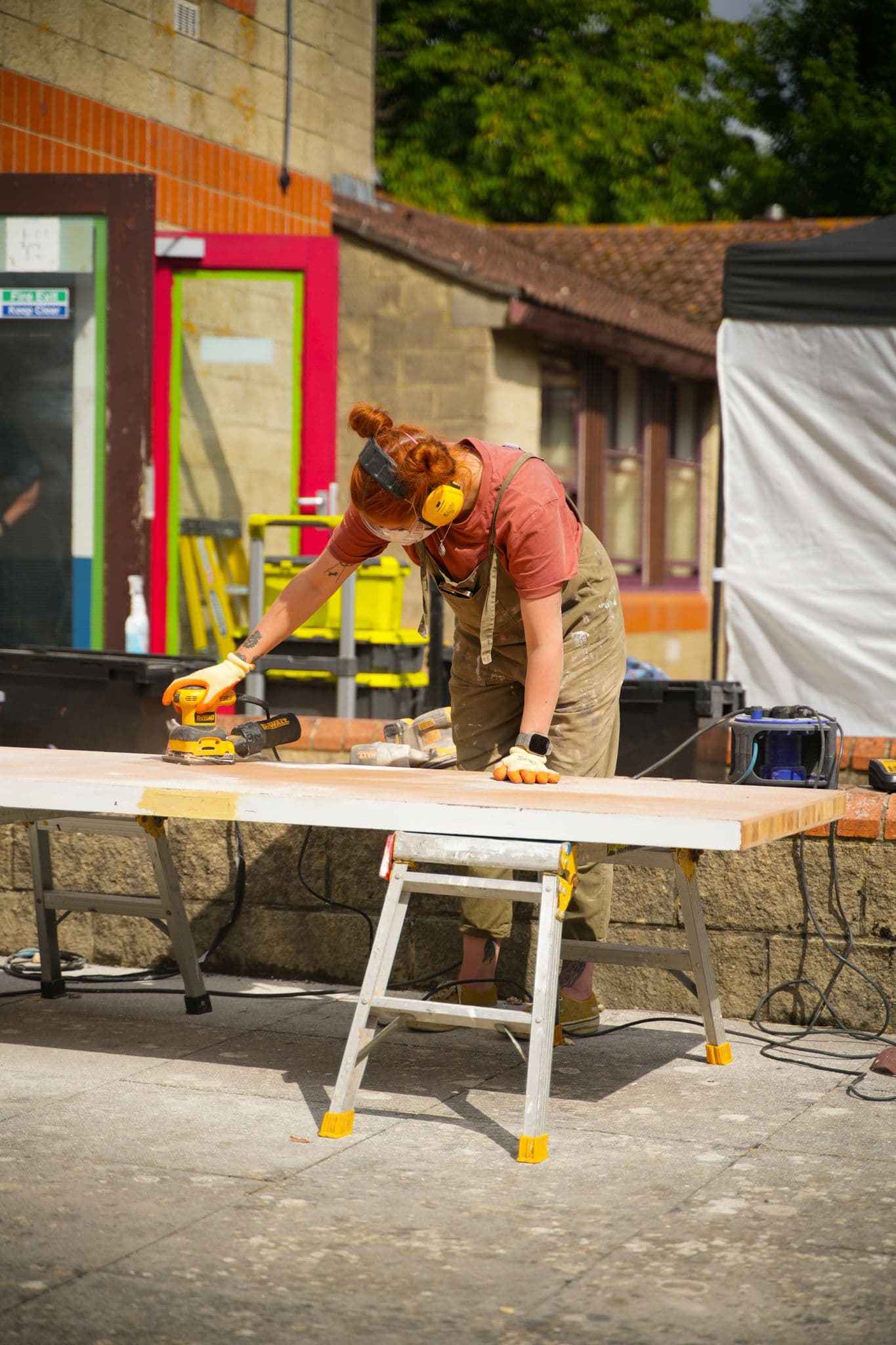 Hard at work sanding down the fire doors I sourced for the kitchen worktops